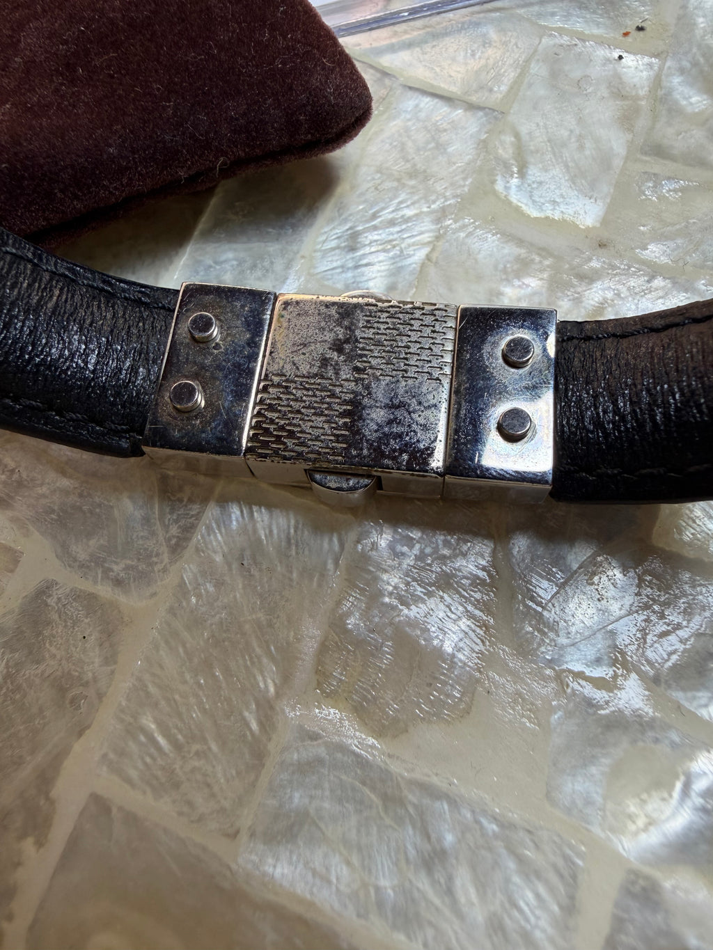 Close-up of Louis Vuitton bracelet textured band and clasp