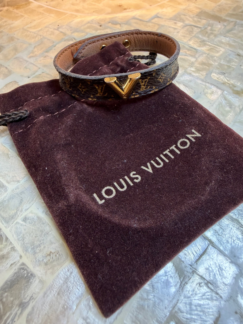 Close-up of Louis Vuitton Damier Graphite cuff bracelet