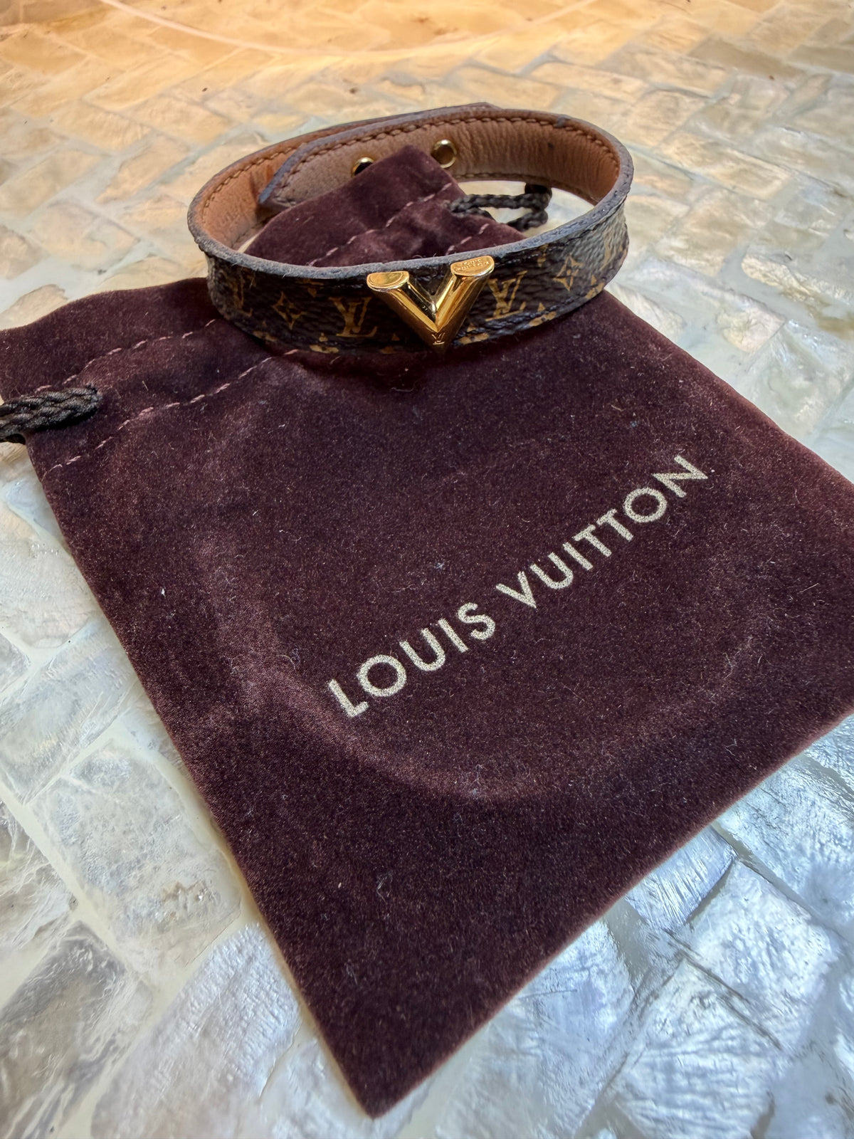 Close-up of Louis Vuitton Damier Graphite cuff bracelet