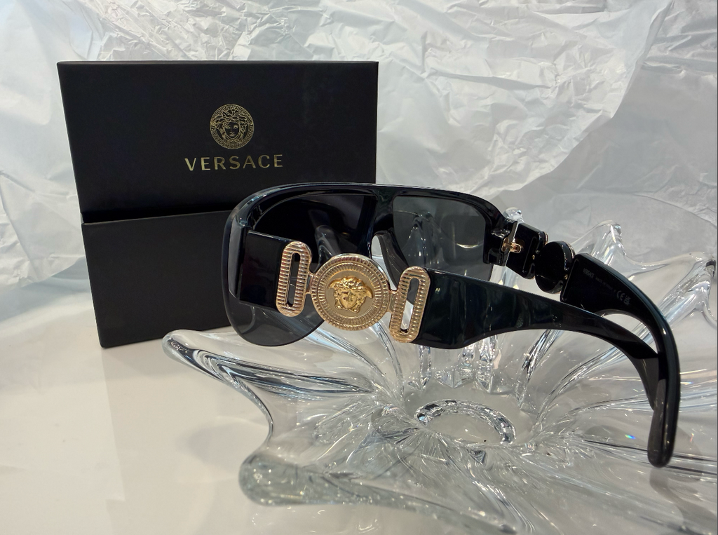 Versace VE4381 front view with gold Medusa medallion on crystal display
