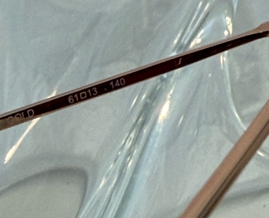 Draper James DJ9028 rose gold aviator sunglasses front view on crystal display