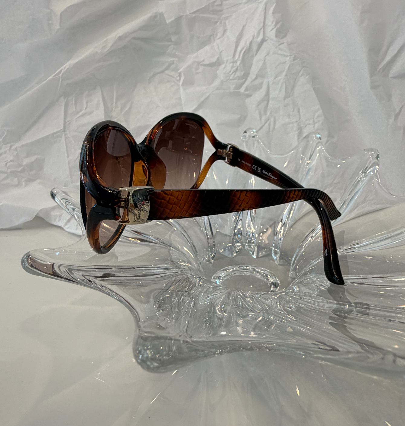Salvatore Ferragamo oversized butterfly sunglasses front view on crystal display showing brown gradient lenses