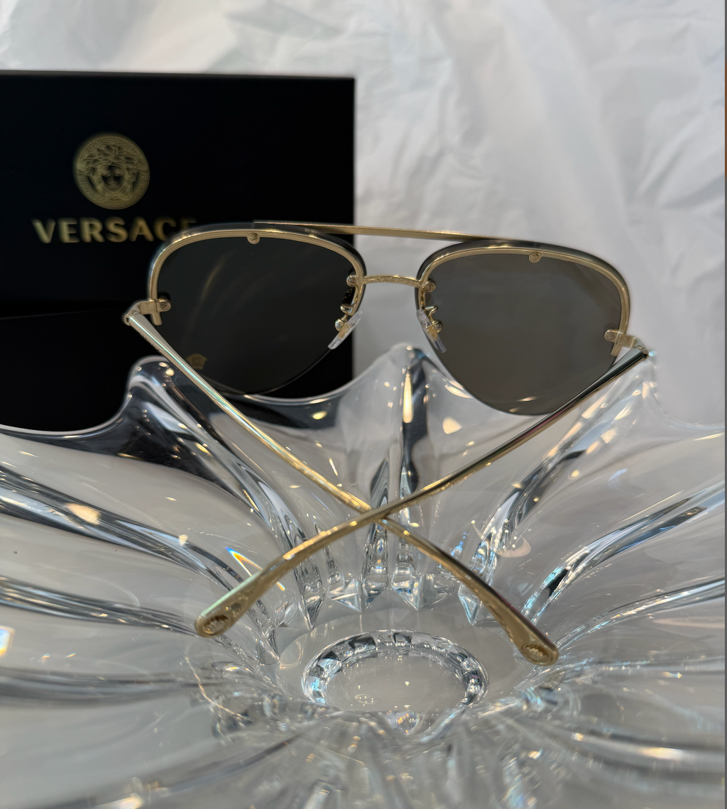 Versace MOD 2231 gold rimless aviator sunglasses side view showing grey-green gradient lenses