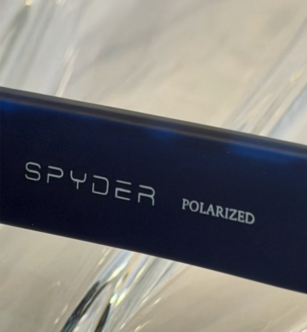 Spyder POLARIZED text detail on dark navy temple arm