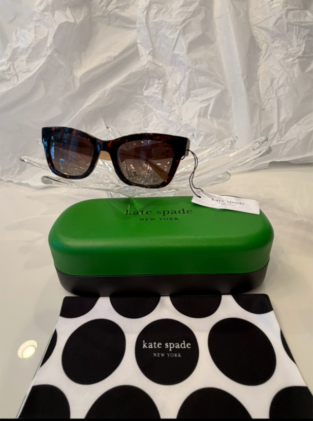 Kate Spade New York Hello Sunshine cat-eye sunglasses back view showing taupe temples crossed on crystal display