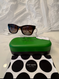 Kate Spade New York Hello Sunshine cat-eye sunglasses back view showing taupe temples crossed on crystal display