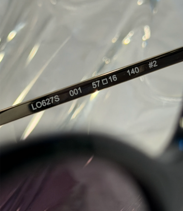 Longchamp LO627S black cat-eye sunglasses front view on crystal display