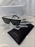 Victoria Beckham VB605S black shield flat-top sunglasses side view on crystal display