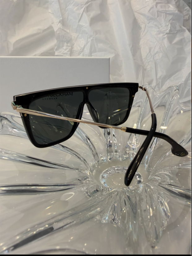 Victoria Beckham VB605S black shield sunglasses top-down view on crystal display