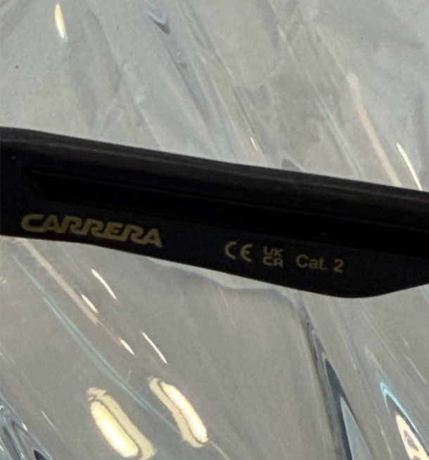 Carrera 4019/S Festival Edition black flat-top sunglasses angled front view on crystal display