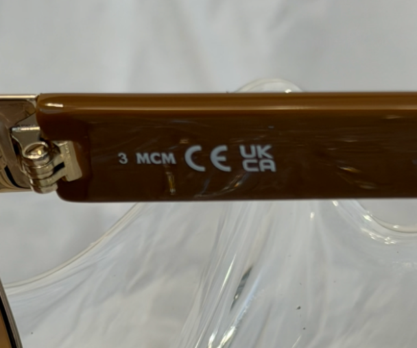 MCM MW0008 hinge detail showing 3 MCM CE UKCA certification markings on brown tortoise temple