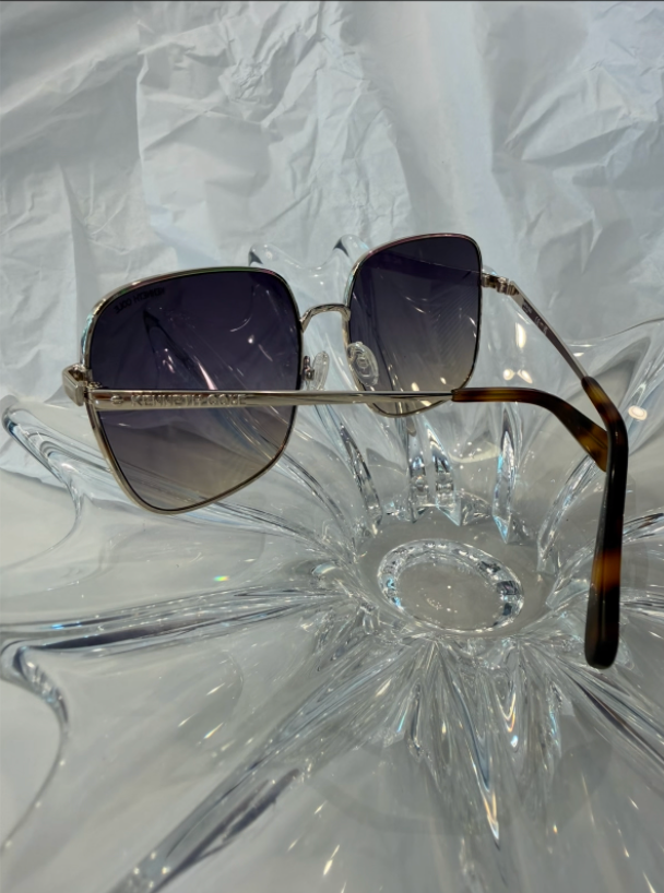 Kenneth Cole Reaction KC00025 silver oversized square sunglasses back view showing tortoise acetate temple tips on crystal display