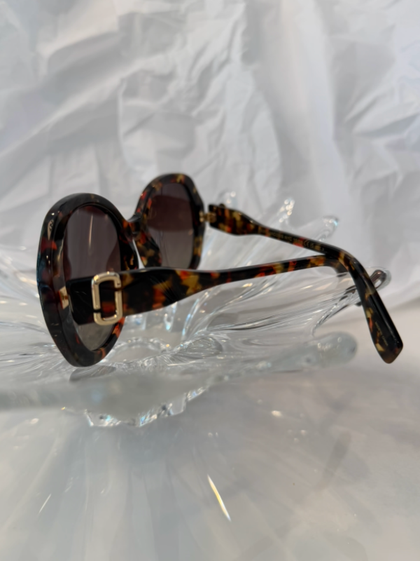 Marc Jacobs MARC 763/S havana tortoise oversized round sunglasses side view showing gold C buckle hinge detail on crystal display
