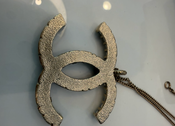 Chanel CC rhinestone pendant side angle view