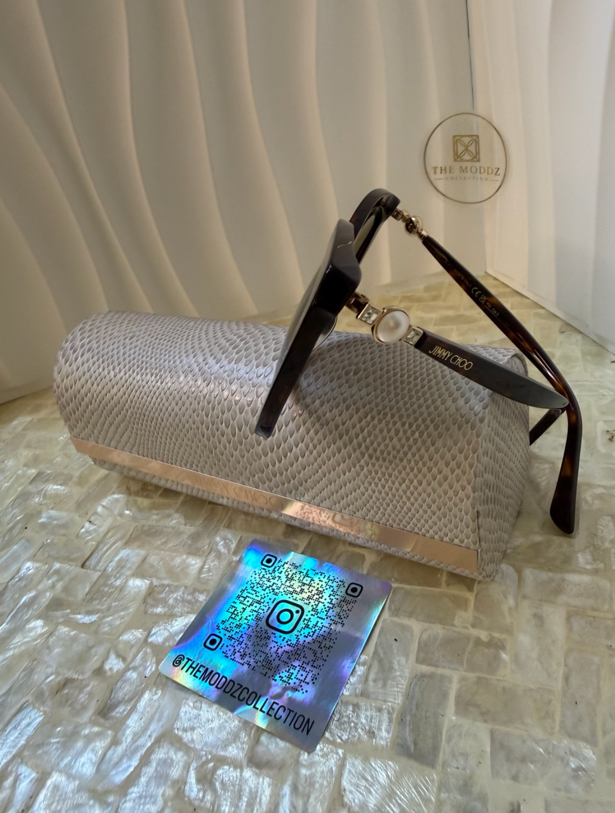 Jimmy Choo cat eye sunglasses with case and dust cloth – overhead view