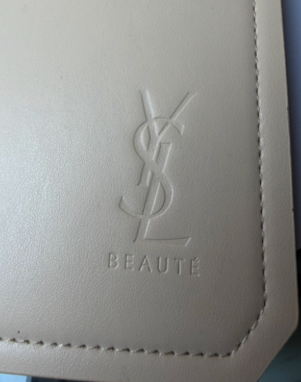 YSL Beauté embossed logo detail on cream leather