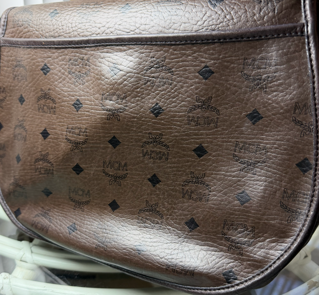 MCM interior zip pocket close-up with MCM gold zipper pull
