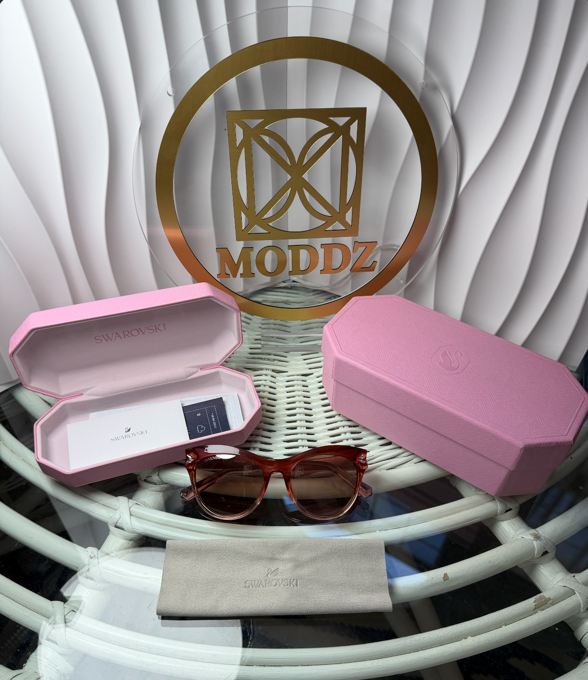 Close-up of Swarovski crystal detail on temple of pink cat-eye sunglasses