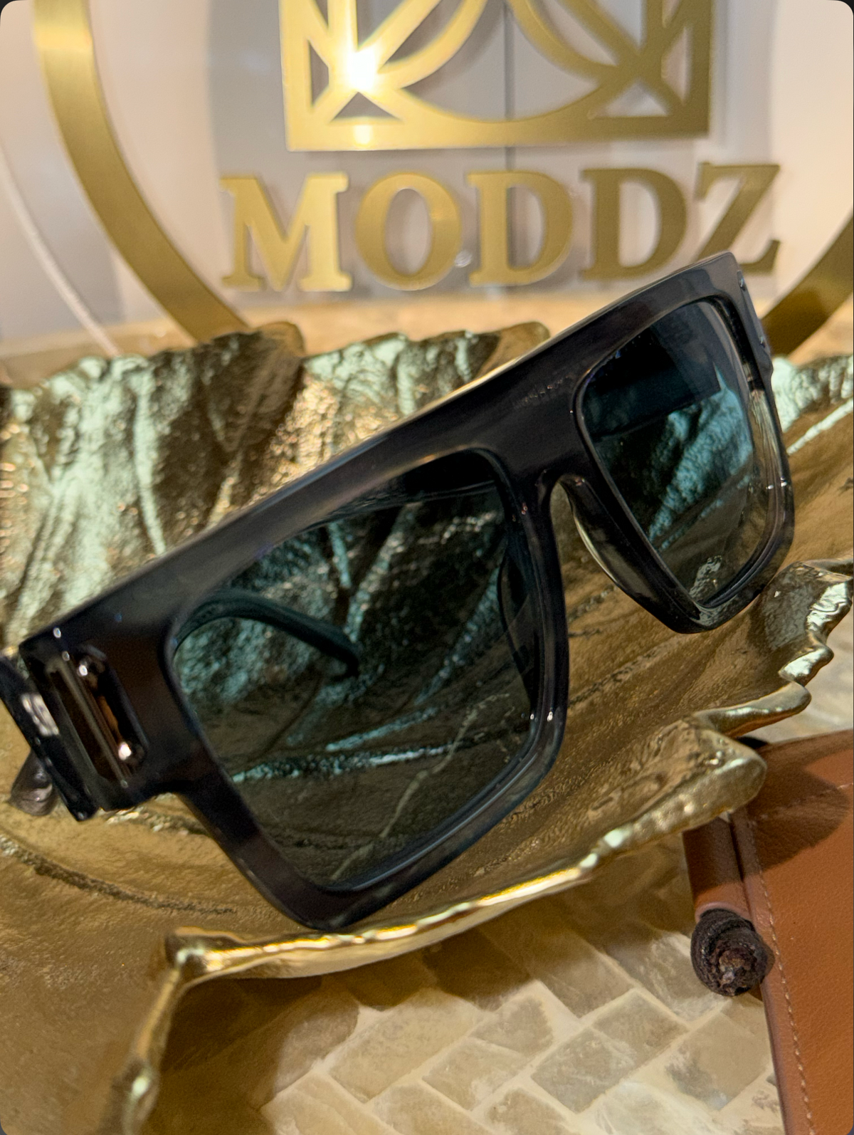 Close-up of MCM Sunglasses #207 black rectangular frame
